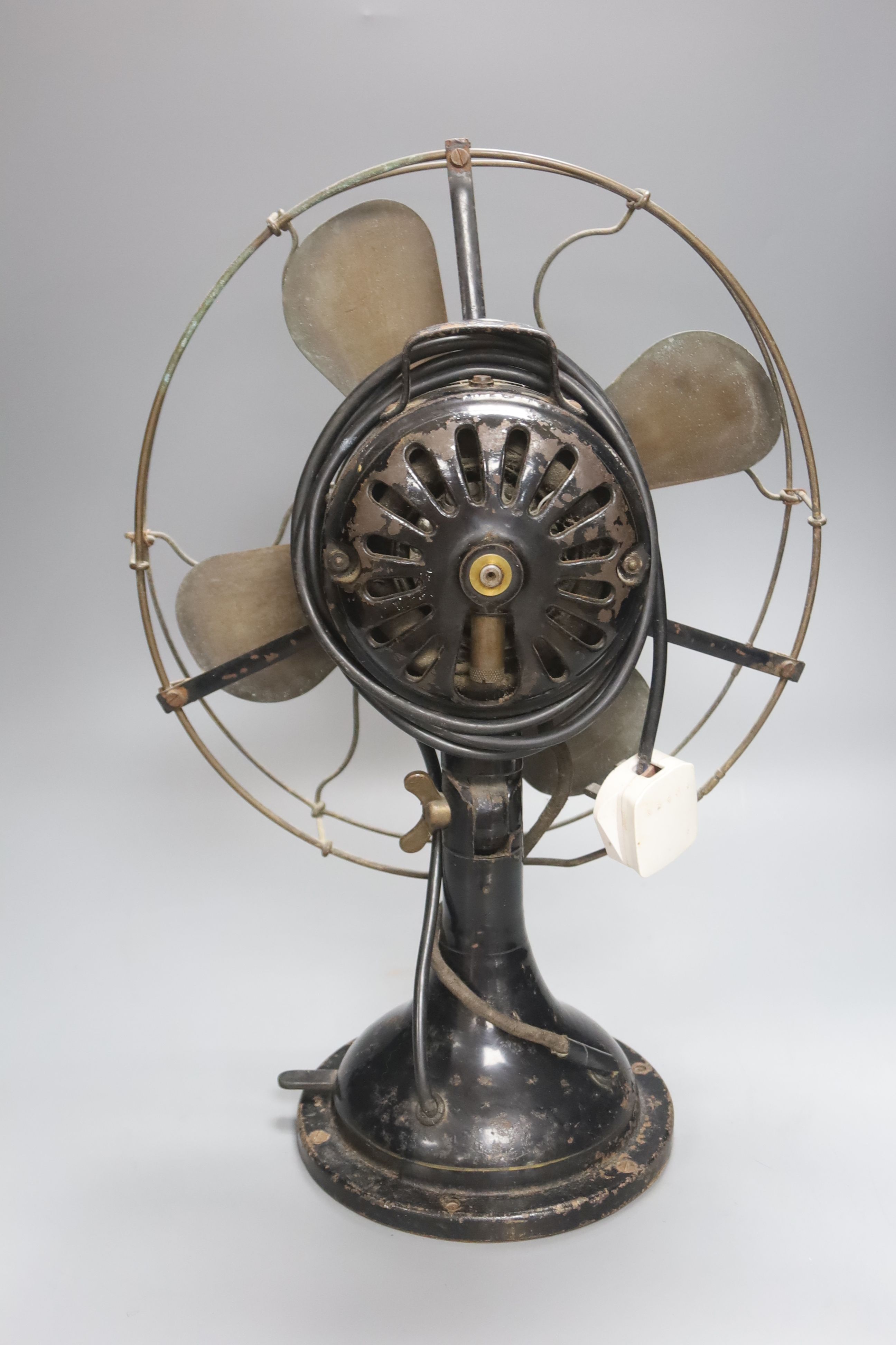 A vintage cast iron and brass propeller desk fan, height 45cm